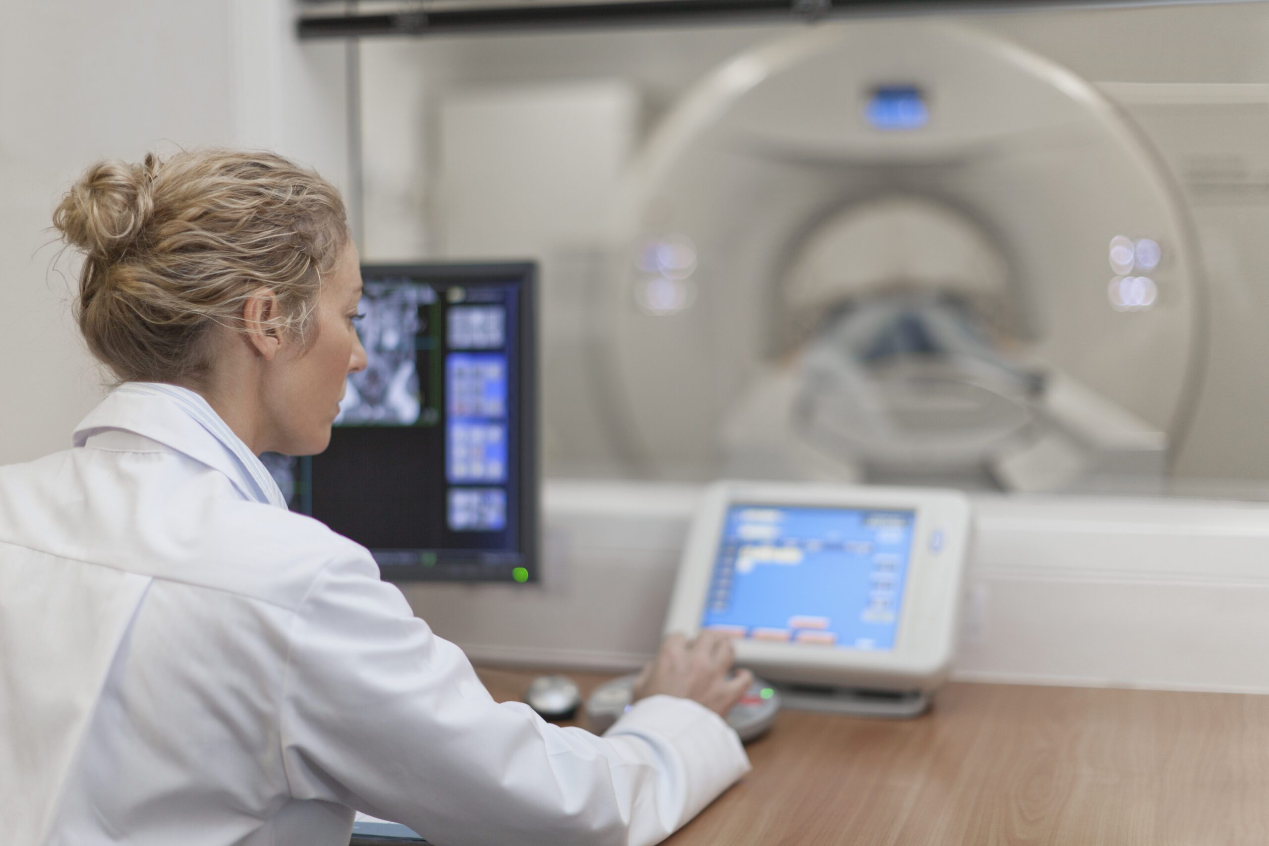 Woman at MRI Machine controls | Healthcare Technology