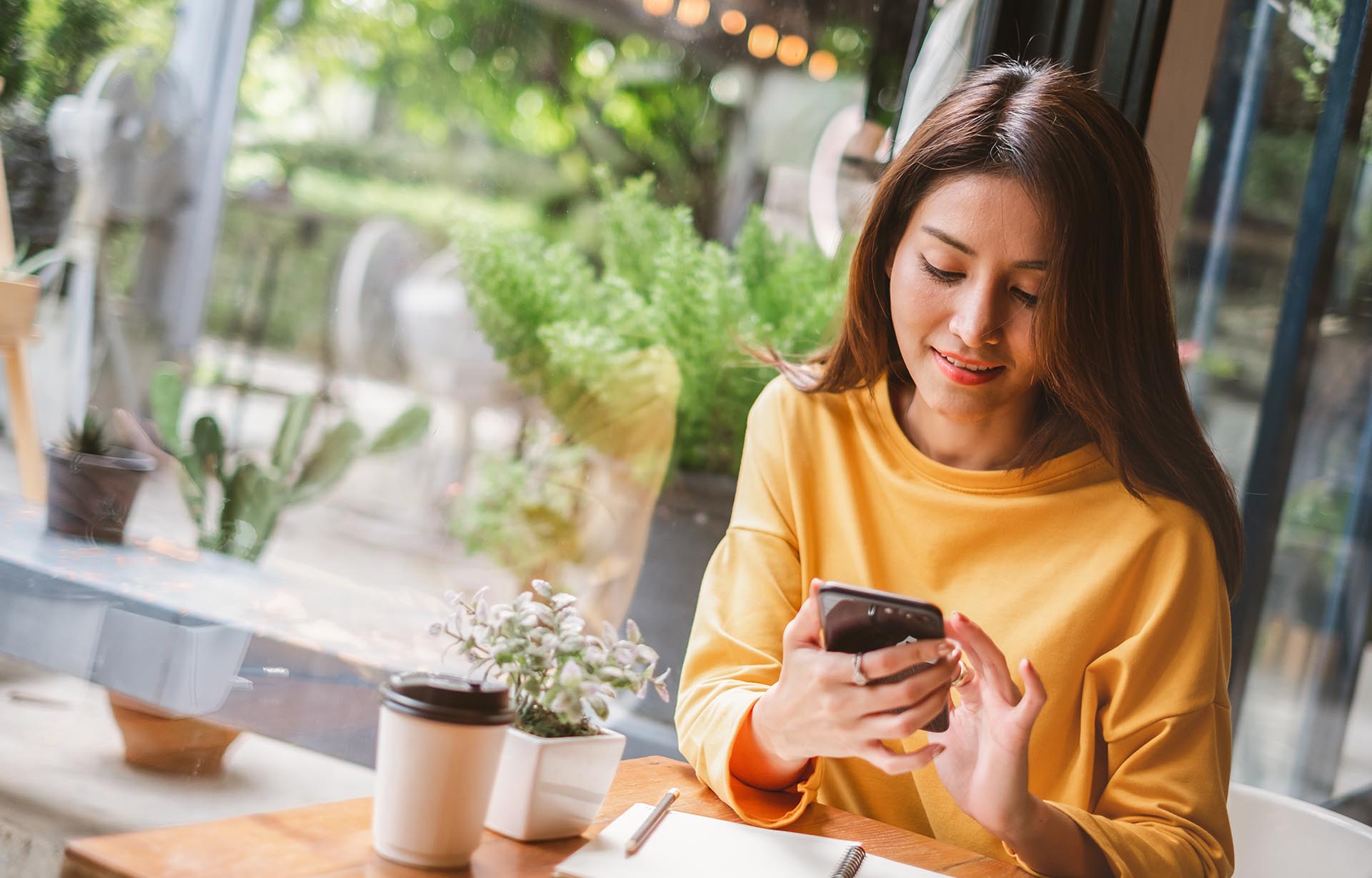 Women at Cafe looking at phone